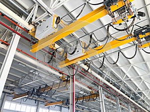 Overhead cranes inside industrial building. Bridge cranes inside hangar