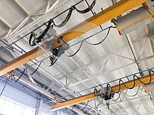 Overhead cranes inside industrial building. Bridge cranes inside hangar
