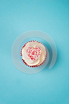 Overhead of Cupcake in Red Wrap with Heart-Shaped Candy