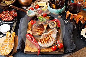 Overhead of dinner table. Assorted delicious grilled barbecue me