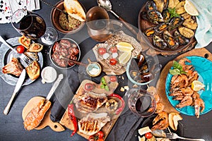 Overhead of dinner table. Assorted delicious grilled barbecue me