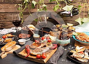 Overhead of dinner table. Assorted delicious grilled barbecue me