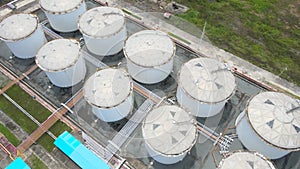Overhead drone shot of row of oil storage tanks