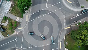 Overhead drone shot of traffic driving over roundabout with highway tunnel