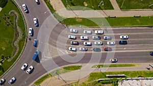 Overhead drone top down shot of busy roundabout with cars and trucks