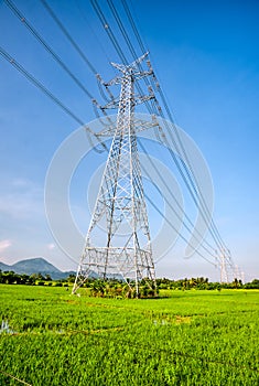 Overhead eletrical transmission line crossing the rice field at Philippine countryside