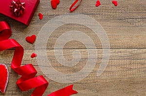 Overhead flat lay valentine day background.Red hearts, gift box and ribbon on wood shabby background. Copy space