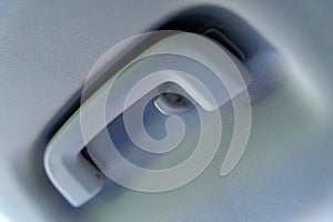 Overhead grab handle in car, showing handle and coat hook