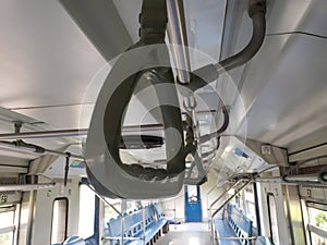 Overhead Handrail and Seats Inside a Train Car
