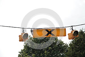 overhead hanging pedestrian crosswalk light yellow sign symbol with lights