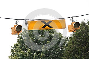 overhead hanging pedestrian crosswalk light yellow sign symbol with lights