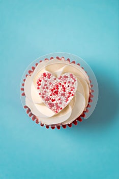 Overhead of Heart-Shaped Candy on Cupcake for Valentine`s Day