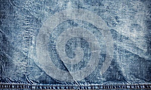 An overhead image featuring a flat background crafted from distressed light wash denim material