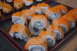 Overhead japanese sushi food. Maki ands rolls with tuna, salmon, shrimp, crab and avocado. Top view of assorted sushi, all you can