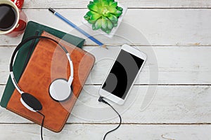 Overhead of music instruments and technology background concept.Several objects on modern rustic wood office desk.