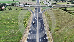 An overhead perspective of a highway featuring two lanes for vehicles to travel. The road stretches into the distance