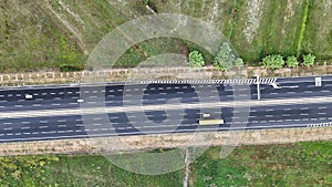 An overhead perspective of a highway featuring two lanes for vehicles to travel. The road stretches into the distance