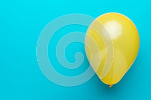 Overhead photo of balloon on the turquoise blue background with copy space