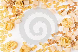 An overhead photo of different types of pasta, including spaghetti, penne, fusilli, and others