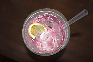 Cocktail drink with lemon silice pink liquid photo