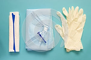An overhead photo of the vaginal speculum, napkin, medicine gloves and spatula. The medical tools for holding open the vagina duri