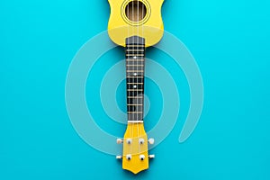 Overhead photo of yellow ukulele with copy space