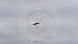 overhead plane flies in the cloudy sky. military exercises.