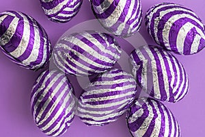Overhead of purple striped easter eggs on purple background