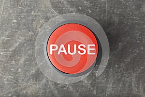 Overhead of Red Pause Push Button on Concrete Background