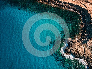 Overhead Rocky sea shore with crystal clear blue water, Cyprus, Blue Lagoon