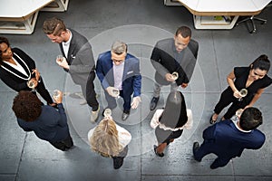 Overhead Shot Of Business Team Socializing At After Works Drinks In Modern Office photo