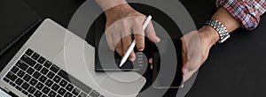 Overhead shot of businessman looking information on smartphone on black desk