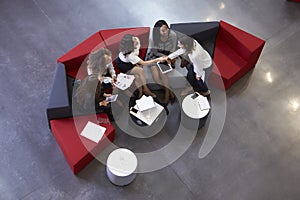 Overhead Shot Of Businesswomen Meeting In Lobby Of Office