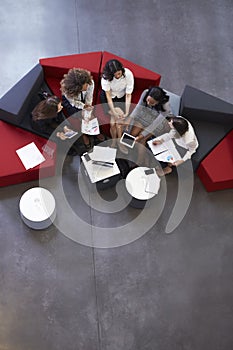 Overhead Shot Of Businesswomen Meeting In Lobby Of Office