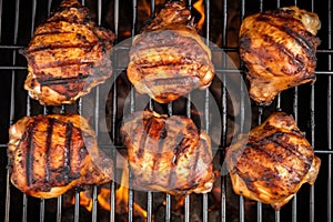 overhead shot of chicken thighs on a grill, fully cooked