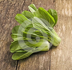 Overhead shot of Chinese cabbage, Bok Choy, on rustic wood