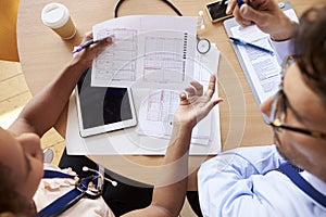 Overhead shot of doctors in consultation over patient notes