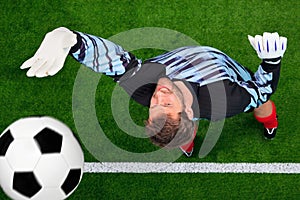 Overhead shot of a goalkeeper missing the ball.