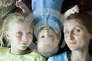 Overhead shot of happy family with mother and two adorable siblings