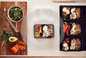 Overhead Shot Of Ingredients And Containers For Batch Of Healthy Meals At Home On Kitchen Counter