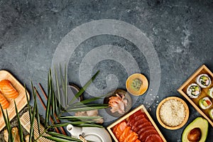 Overhead shot of ingredients for sushi on dark blue background