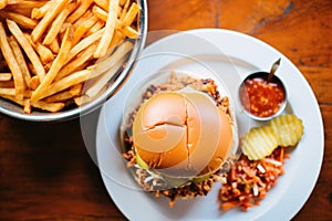 overhead shot of a loaded sloppy joe with side of fries