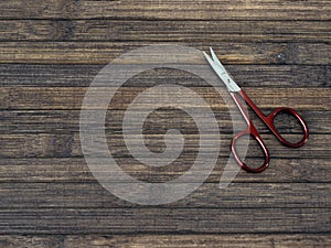 Overhead shot of a manicure scissors on a wooden table