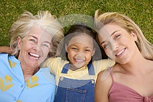 Overhead Shot Of Multi-Generation Female Family Lying On Grass Togther photo