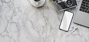 Overhead shot of photographer workspace with mock up smartphone and office supplies