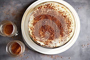 overhead shot of a round tiramisu on a cake stand