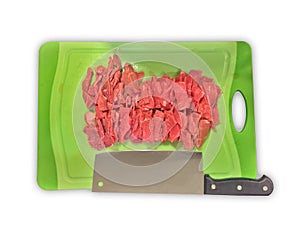 Overhead shot of sliced beef with a knife on a green chopping board isolated on a white surface