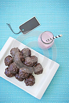 Overhead shot of strawberry milkshake and truffles