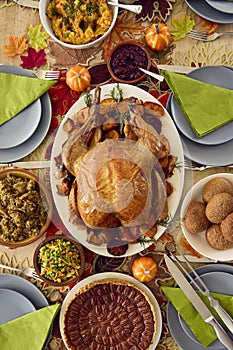 Overhead Shot Of Table Set For Thanksgiving Meal With Turkey And Pumpkin Pie Topped With Pecans