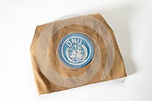 Overhead shot of UN Peacekeeper`s armband on white